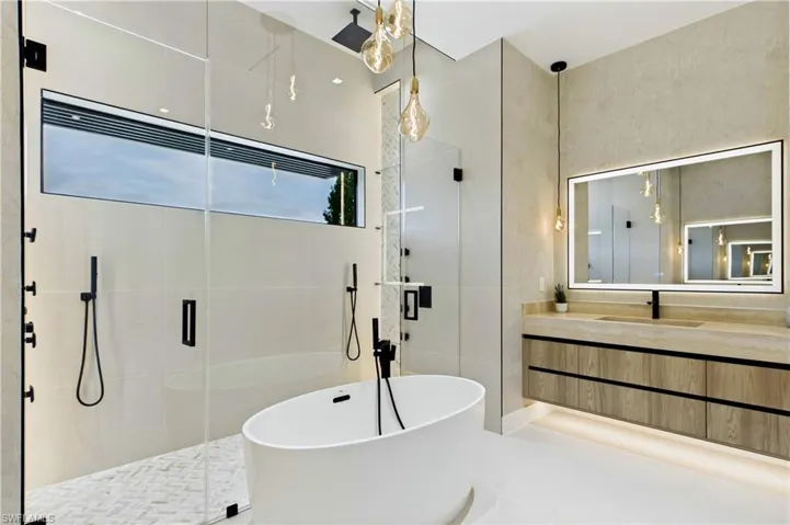 DOUBLE RAINFALL SHOWERS w/ 4 jets & handheld showerheads, STANDALONE TUB & custom vanities