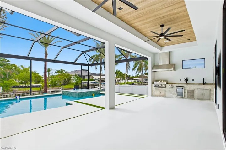 Covered patio w/ wood ceiling, fan, INTEGRATED BOSE SURROUND SOUND SYSTEM & 65” TV