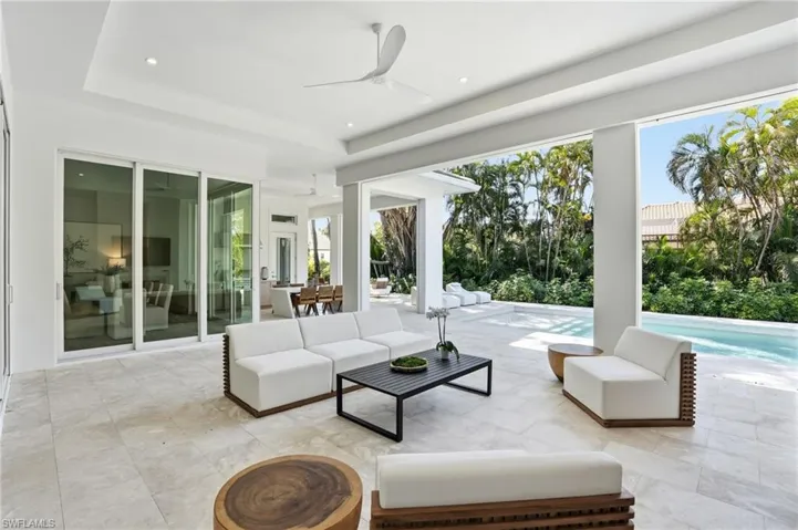 View of patio / terrace featuring ceiling fan, an outdoor living / dining area, and an outdoor pool