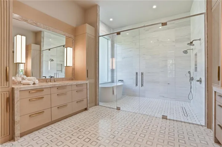 Bathroom featuring vanity and a shower stall