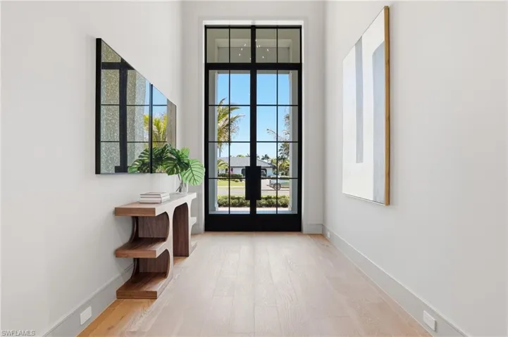 Doorway with hardwood / wood-style flooring, french doors, and a high ceiling