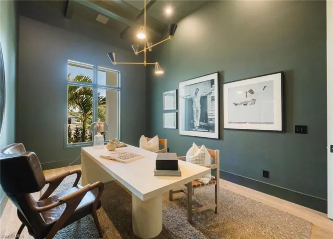 Office featuring light wood-style flooring and a high ceiling