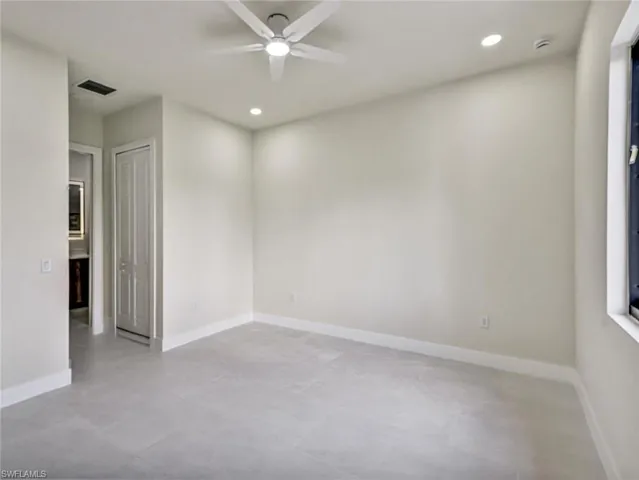 Neutral-toned room featuring a ceiling fan with integrated lighting, recessed lighting, and light gray tile flooring