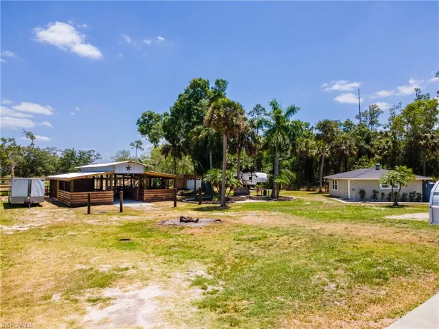 View of green lawn featuring an outdoor structure