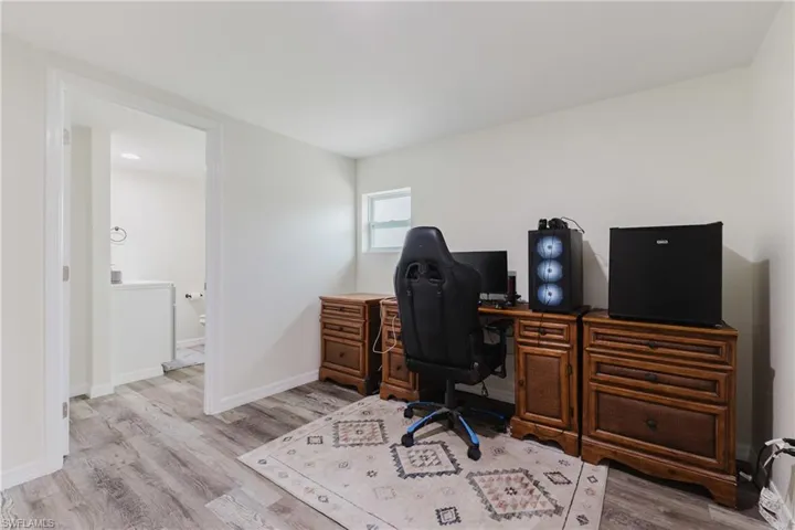 Office featuring wood finished floors and baseboards