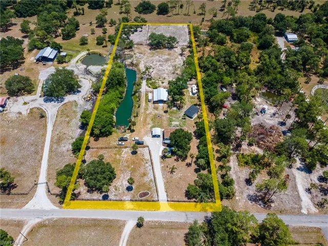 Aerial view of property's location with property parcel outlined and a nearby body of water