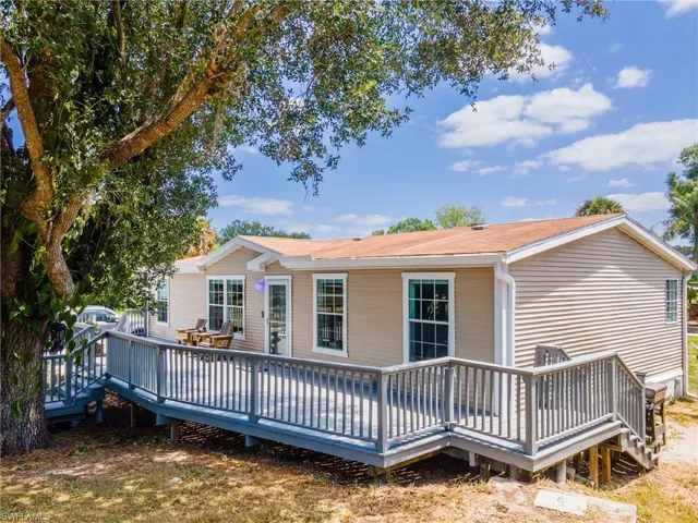 Back of house with a wooden deck