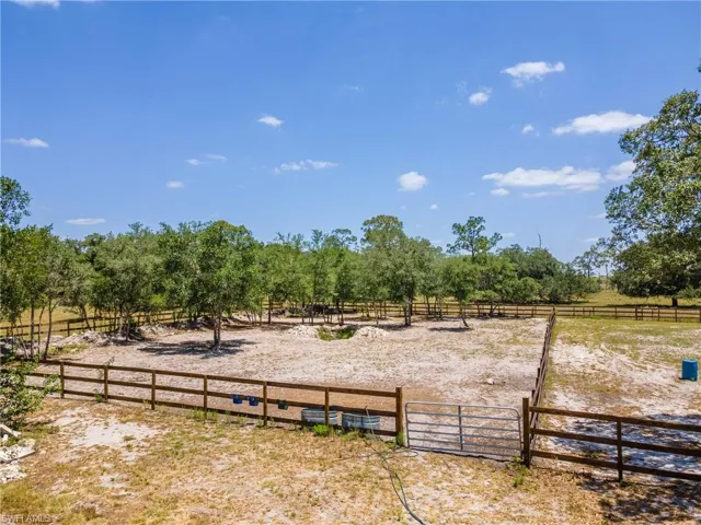View of yard with a view of countryside and an enclosed horse arena