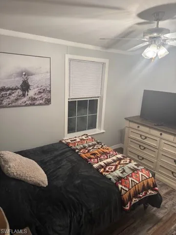 Bedroom featuring wood finished floors and a ceiling fan