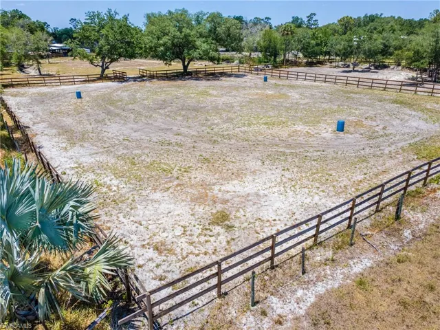 View of yard with an enclosed horse arena and a view of rural / pastoral area