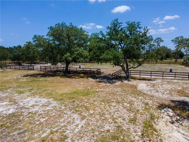 View of yard with a view of countryside and an outdoor riding arena