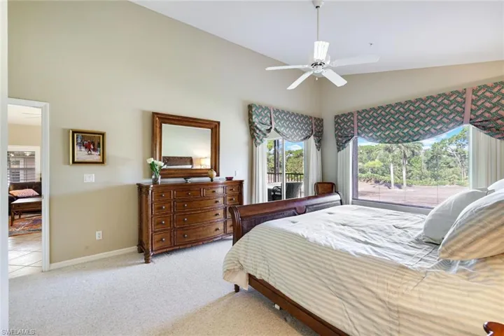 Spacious primary suite with large windows and tranquil views.