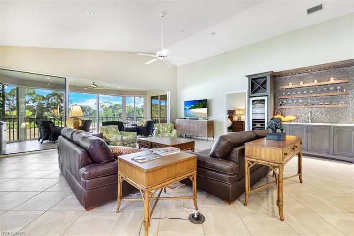 Spacious and light-filled living room with peaceful golf views and easy access to the lanai.