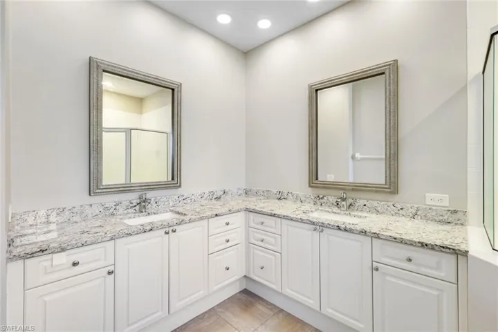 En-suite bath with dual sinks and classic finishes.