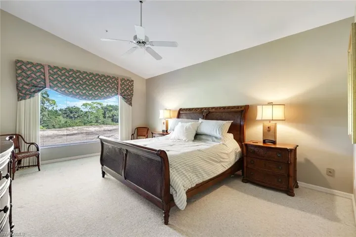 Comfortable primary suite with large window and direct access to the lanai.