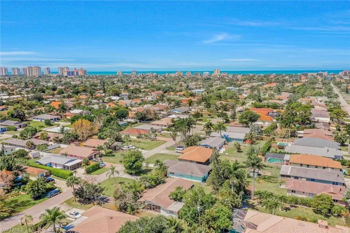 Aerial perspective of suburban area with a nearby body of water