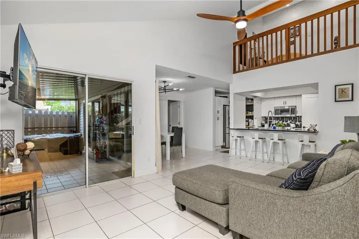 Great Room with Vaulted Ceiling & New Ceiling Fan, Dining Area, Kitchen with Breakfast Bar, & Second Floor Loft