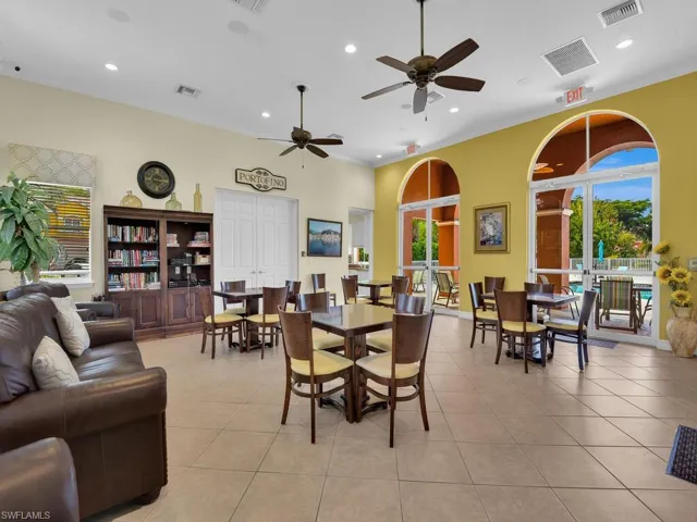 Dining area with crown molding, plenty of natural light, recessed lighting, light tile patterned flooring, and ceiling fan