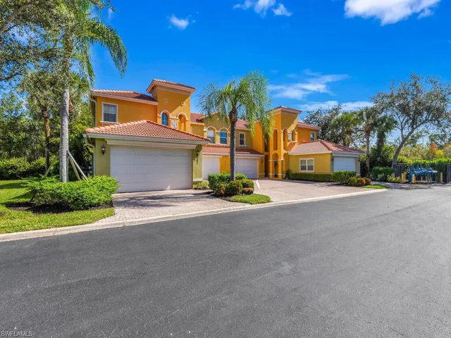 Mediterranean / spanish home featuring stucco siding, driveway, a garage, and a tile roof