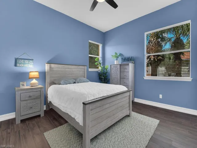Bedroom with ceiling fan and dark wood-style floors