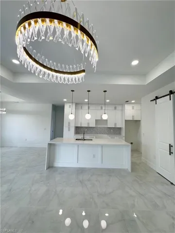 Bathroom featuring a stall shower, marble look tiles, and recessed lighting