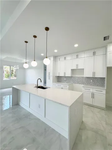 Bathroom featuring vanity, a shower stall, and marble finish floors