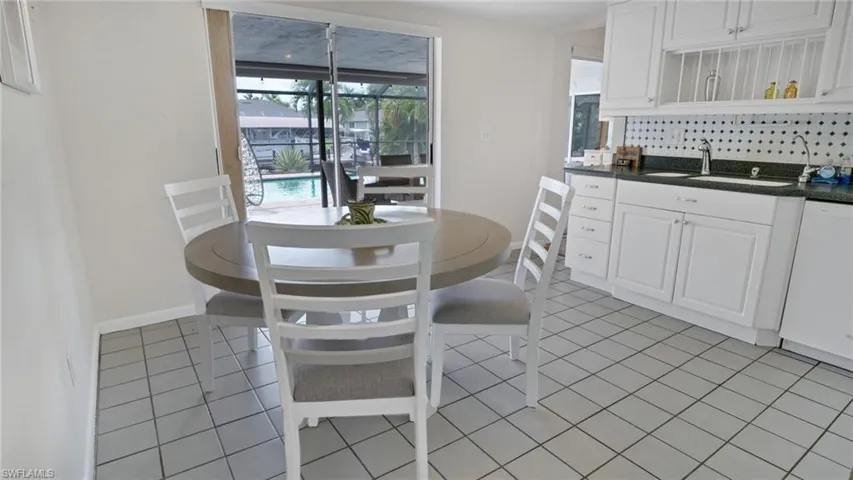 Dining space featuring light tile patterned floors