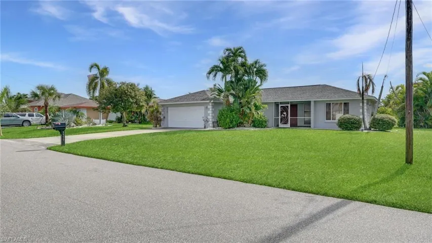 Single story home with driveway, a front lawn, a garage, and a shingled roof