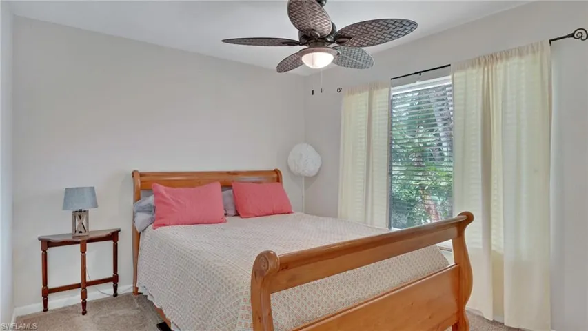 Bedroom with light carpet and ceiling fan