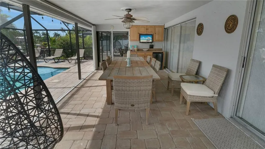 Sunroom featuring a patio area and ceiling fan