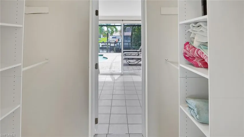 Walk in closet with tile patterned flooring