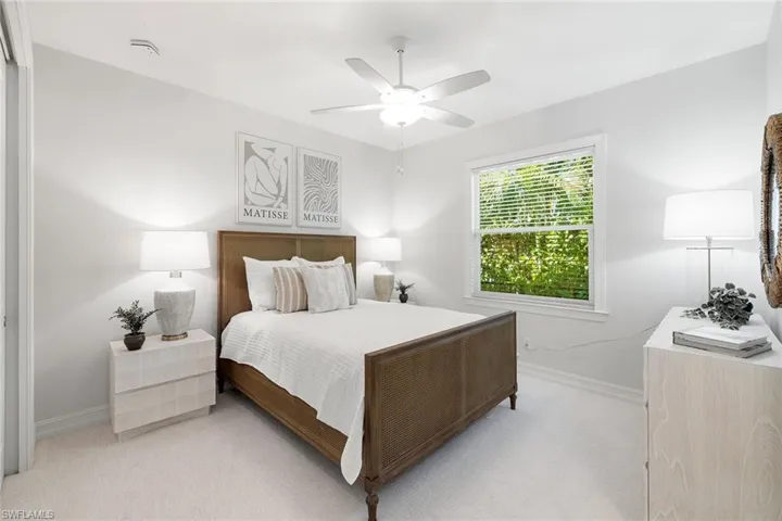 Carpeted bedroom featuring baseboards and a ceiling fan