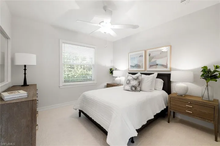 Bedroom featuring light colored carpet and ceiling fan