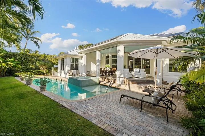 View of pool with a patio, a yard, outdoor dining area, an outdoor hangout area, and a pool with connected hot tub