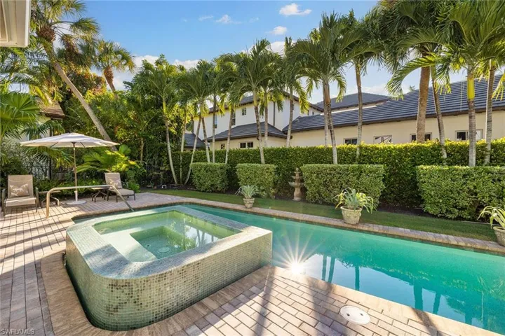 View of swimming pool with an in-ground hot tub and a patio