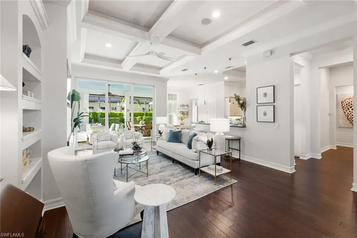 Living room with coffered ceiling, dark wood-type flooring, beamed ceiling, a ceiling fan, and recessed lighting