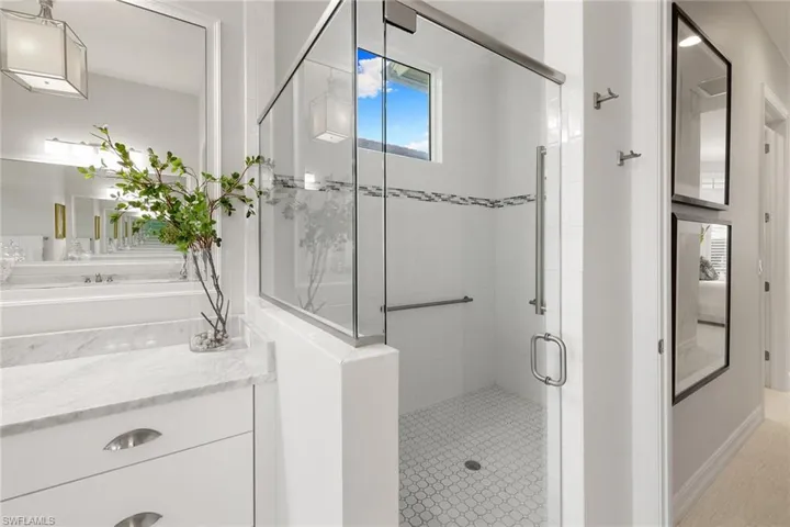 Bathroom featuring a shower stall and vanity