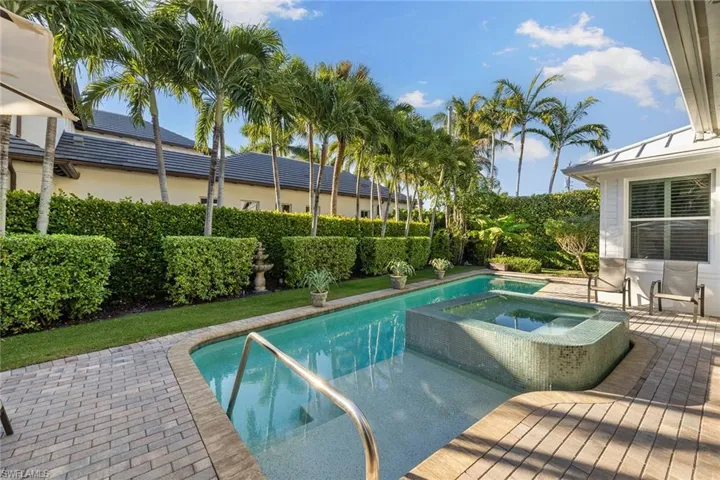 View of pool featuring a patio area and a pool with connected hot tub