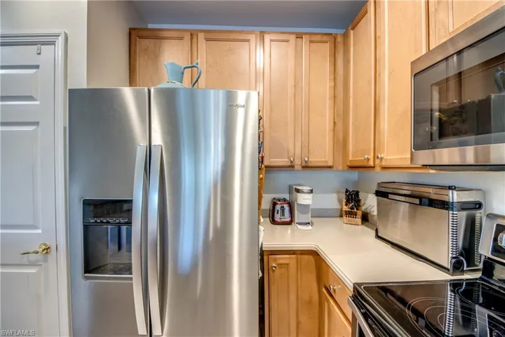 Kitchen with stainless steel appliances and light brown cabinets