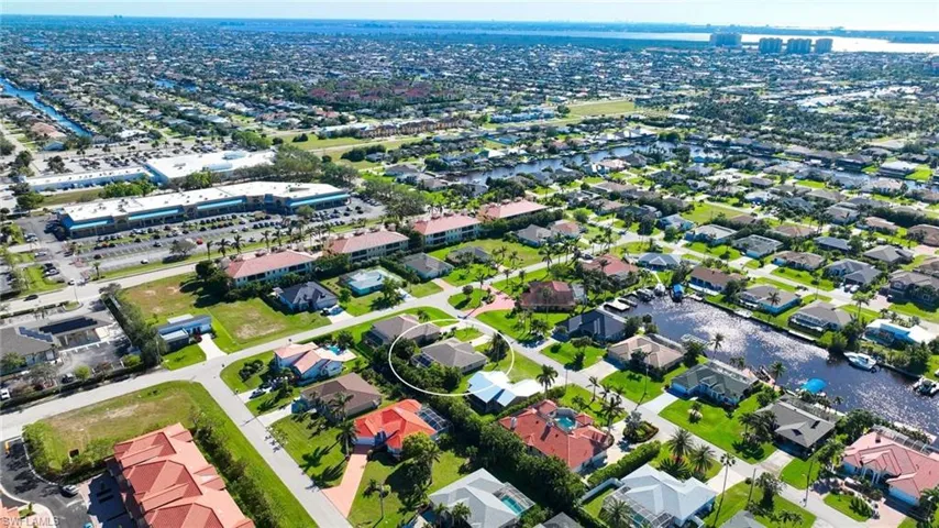 Aerial view of property's location featuring a large body of water and nearby suburban area