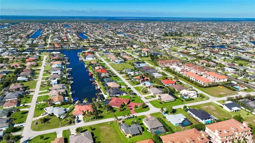 Aerial view of residential area featuring a large body of water