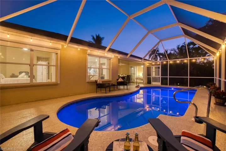 Swimming pool with a sunroom, a patio, and a lanai