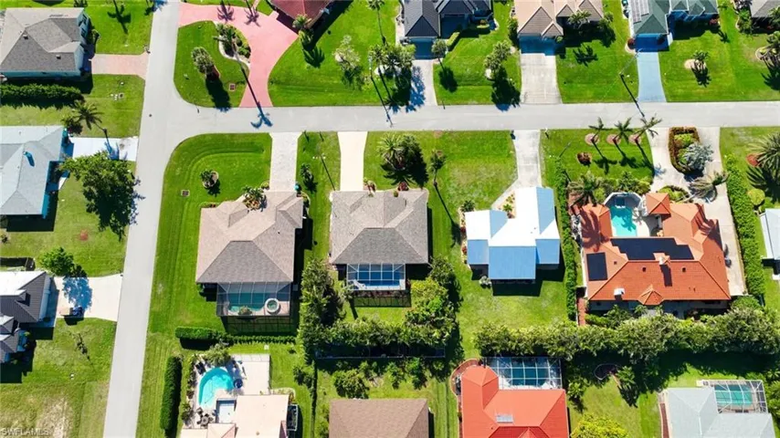 Aerial view of residential area featuring a pool