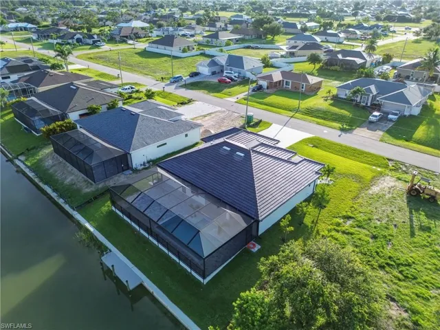 Aerial view of residential area featuring a large body of water