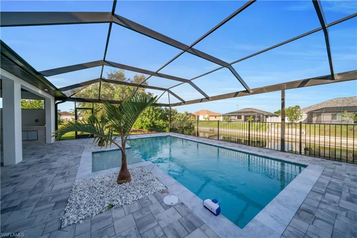 View of swimming pool with a patio area and a lanai
