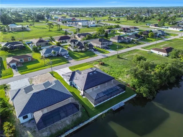 Aerial perspective of suburban area with a nearby body of water