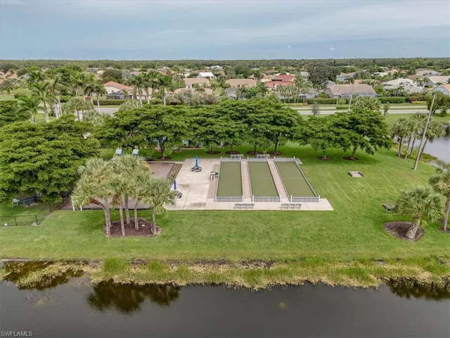 Aerial view of property's location featuring a large body of water and nearby suburban area
