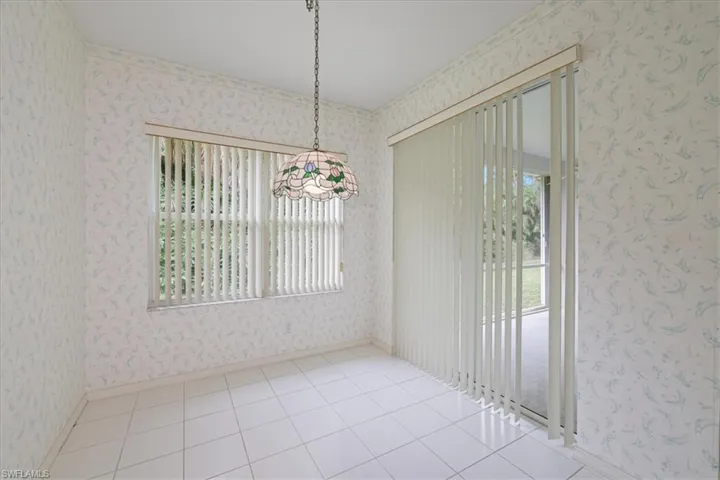 Unfurnished room featuring wallpapered walls and light tile patterned floors