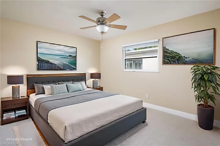 Freshly painted bedroom with new carpet flooring and ceiling fan