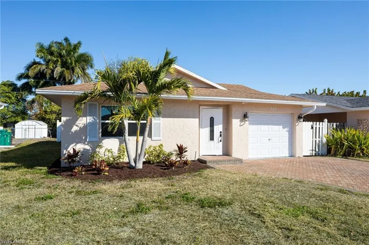 Ranch-style home featuring stucco siding, decorative brick paver driveway, and one car garage.